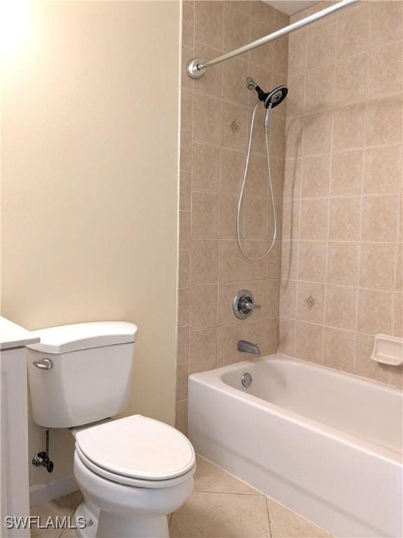 full bathroom featuring tile patterned floors, toilet, tiled shower / bath combo, and vanity