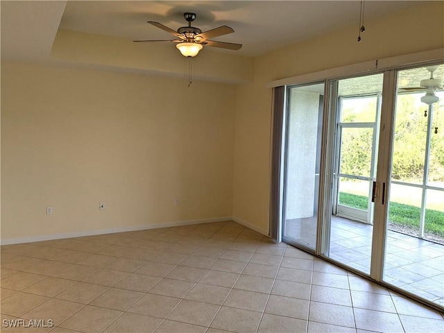 tiled spare room with ceiling fan