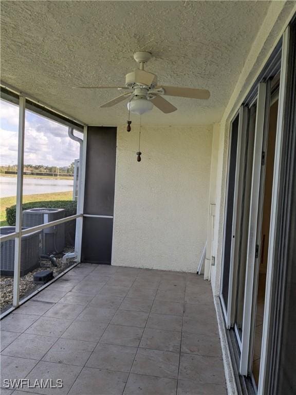 unfurnished sunroom with ceiling fan