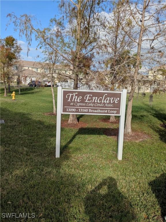 community / neighborhood sign with a yard