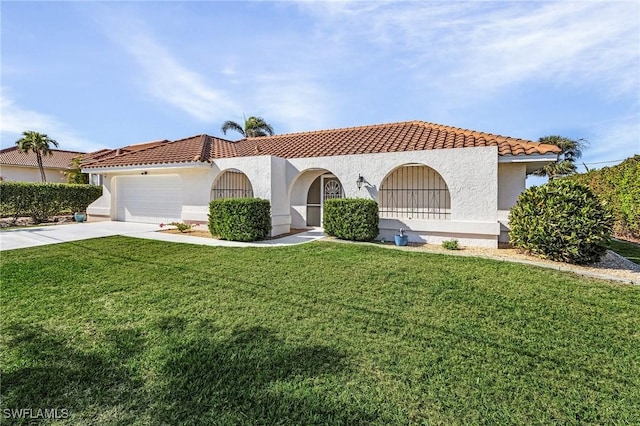 mediterranean / spanish home with a garage and a front lawn