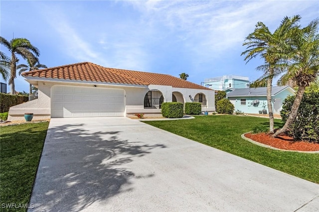 mediterranean / spanish-style house with a garage and a front yard