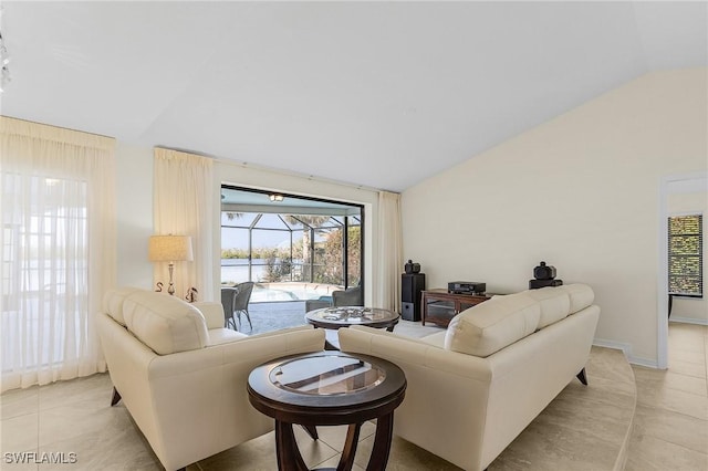 living room featuring lofted ceiling and light tile patterned floors