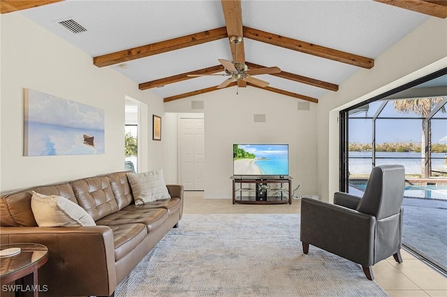 living room with light tile patterned floors, lofted ceiling with beams, and ceiling fan