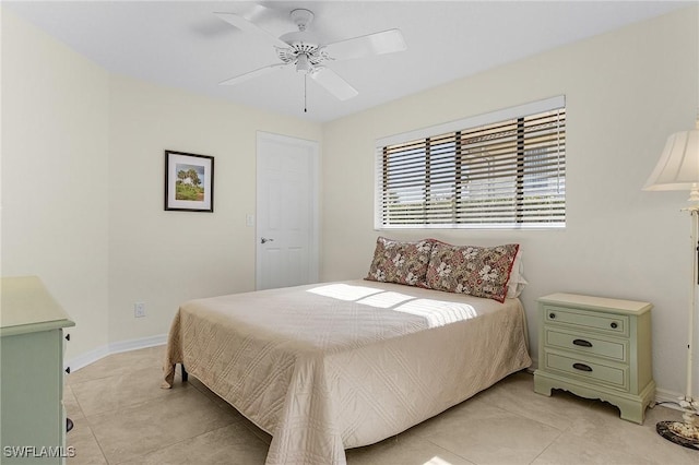 tiled bedroom featuring ceiling fan