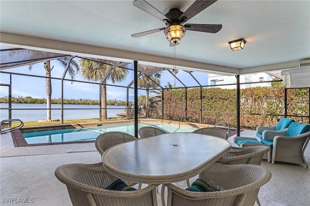 exterior space featuring a swimming pool, ceiling fan, and a water view