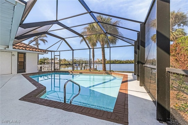 view of pool with a water view, a lanai, and a patio area