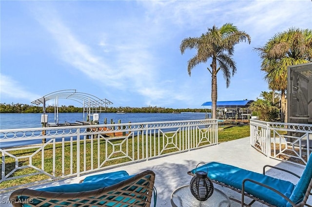 view of patio / terrace with a water view and a boat dock