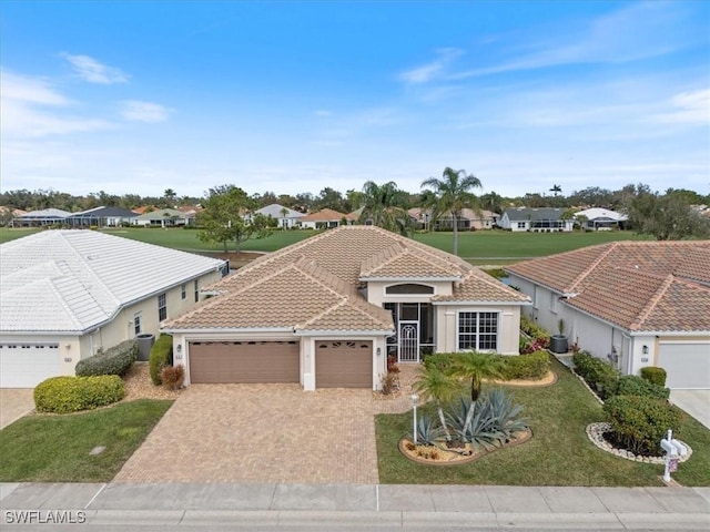 view of front of home featuring a garage and a front lawn