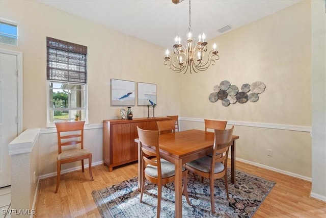 dining area featuring a chandelier and light wood-type flooring