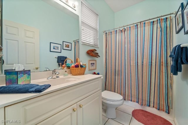 bathroom featuring tile patterned flooring, vanity, and toilet