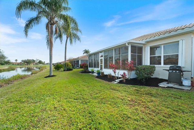 view of yard with a water view and a sunroom