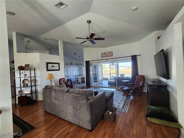 living room featuring vaulted ceiling, dark hardwood / wood-style floors, and ceiling fan