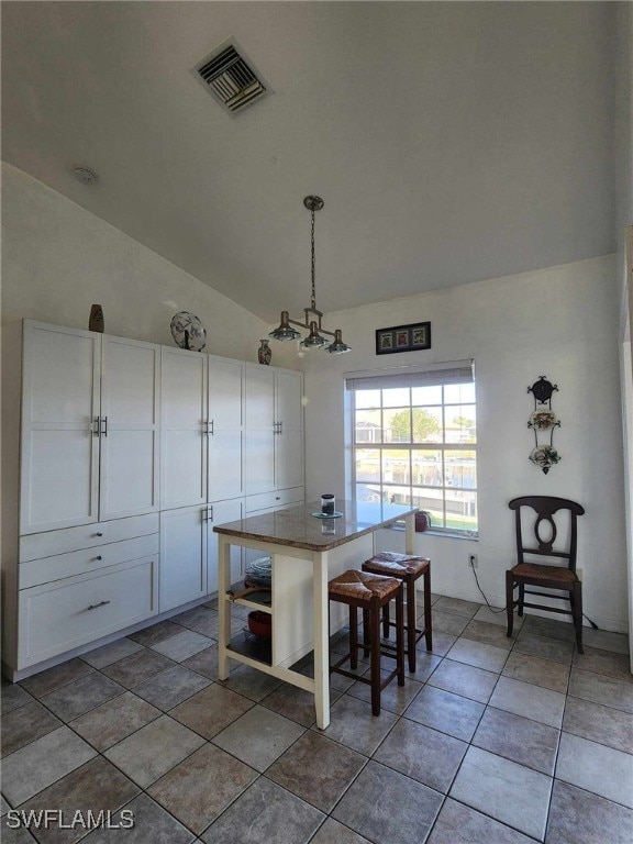 dining area featuring lofted ceiling