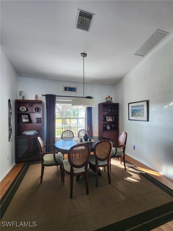 dining space featuring wood-type flooring