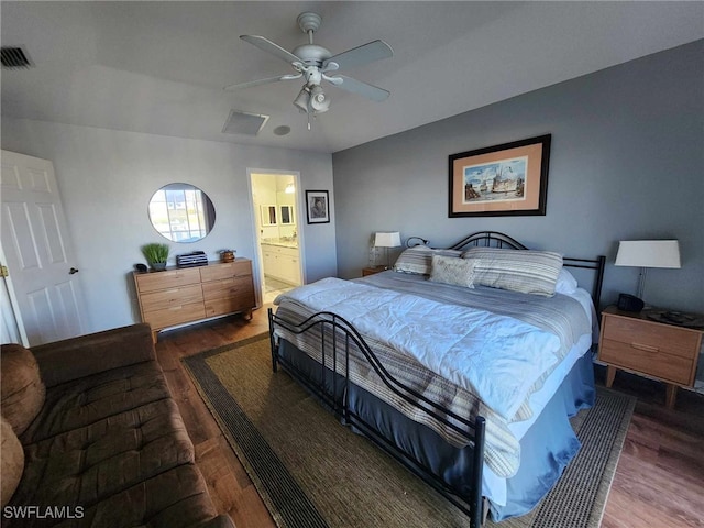 bedroom featuring connected bathroom, hardwood / wood-style floors, and ceiling fan