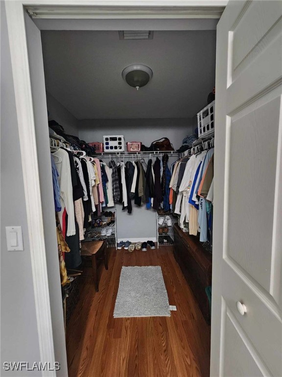 spacious closet featuring hardwood / wood-style flooring