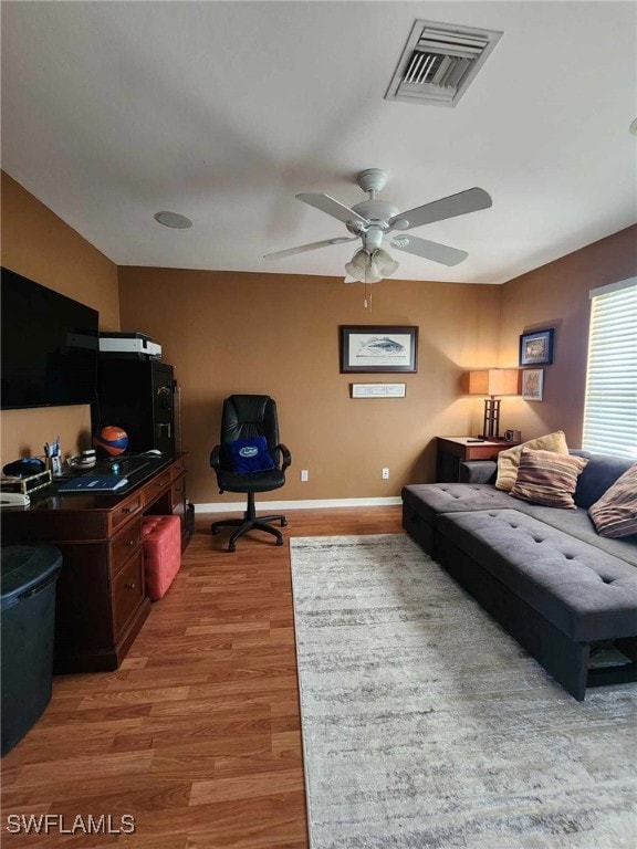 living room with ceiling fan and light wood-type flooring