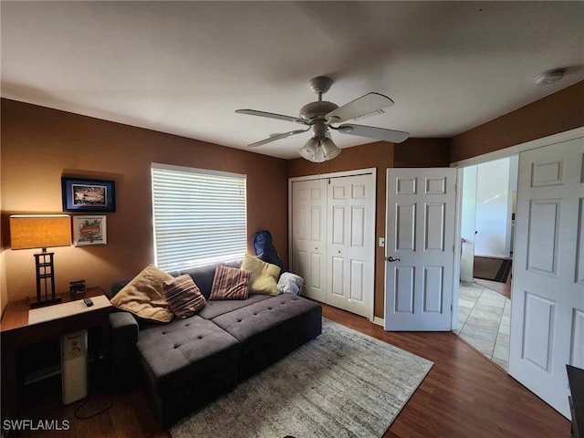 living area with dark hardwood / wood-style floors and ceiling fan