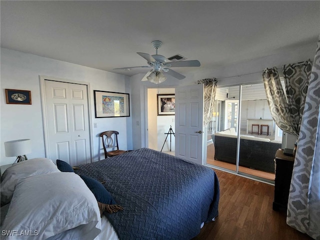 bedroom featuring dark wood-type flooring, ceiling fan, and a closet