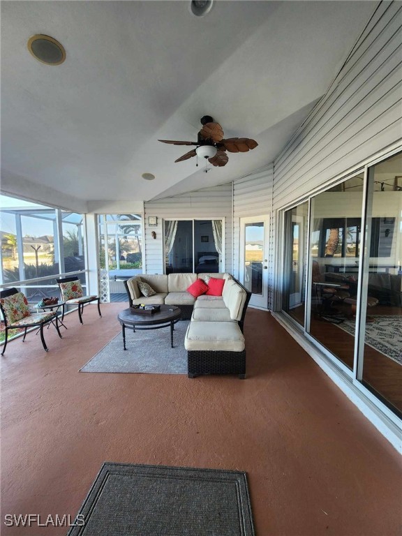 sunroom / solarium with ceiling fan and vaulted ceiling