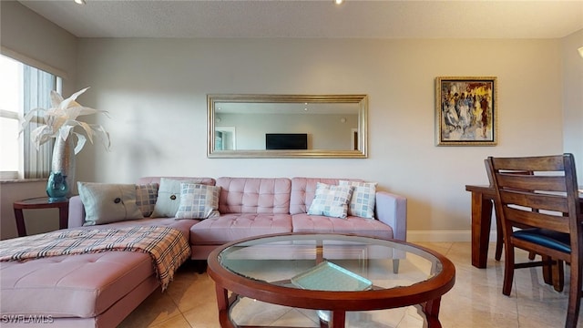 living room featuring a textured ceiling and light tile patterned flooring