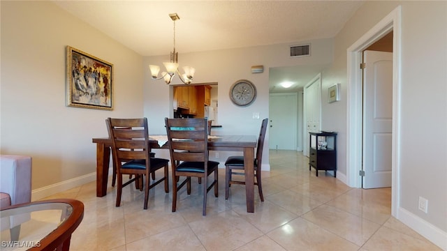 dining room with a chandelier and light tile patterned floors