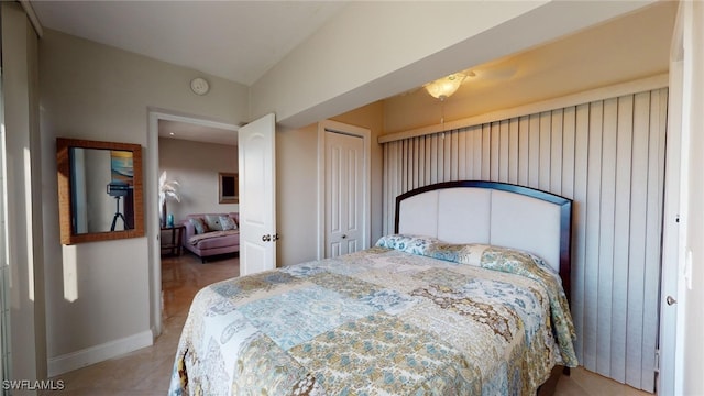 tiled bedroom with a closet