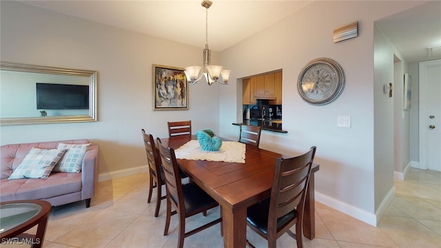 dining room featuring an inviting chandelier, light tile patterned floors, and vaulted ceiling