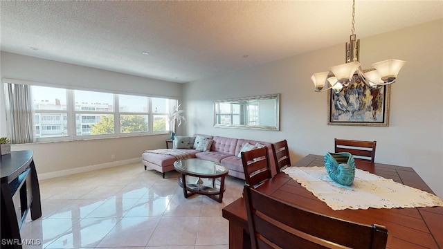 dining space with light tile patterned floors and a textured ceiling