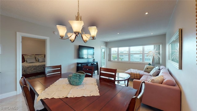 tiled dining space featuring a notable chandelier