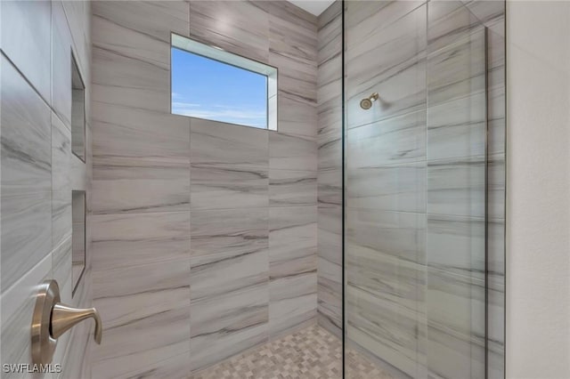 bathroom with tiled shower