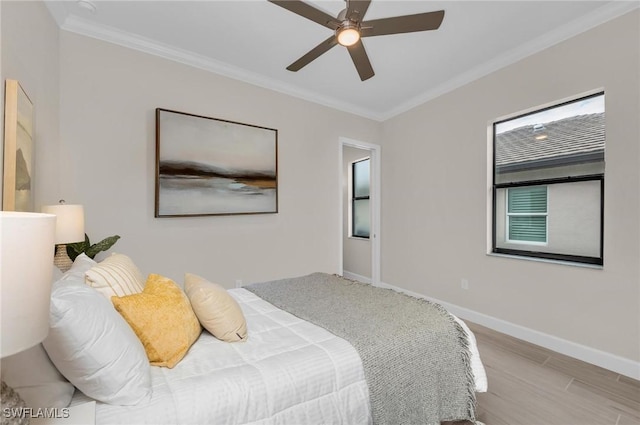 bedroom featuring light hardwood / wood-style flooring, ornamental molding, and ceiling fan