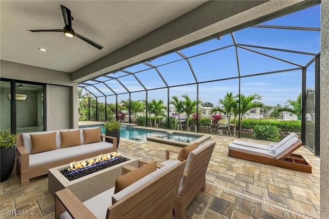 view of patio / terrace featuring a lanai, an outdoor living space with a fire pit, and ceiling fan