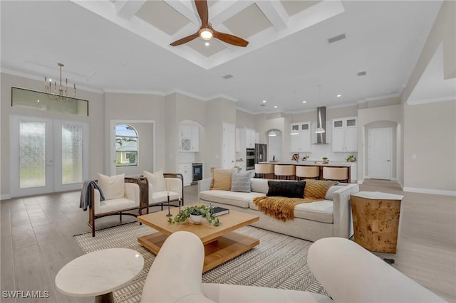 living room featuring french doors, crown molding, beamed ceiling, and light hardwood / wood-style flooring