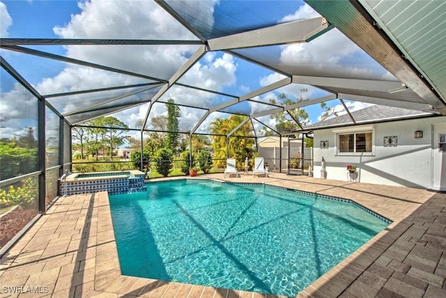 view of pool featuring an in ground hot tub, a lanai, and a patio