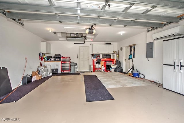 garage featuring a garage door opener, a wall mounted air conditioner, and electric panel