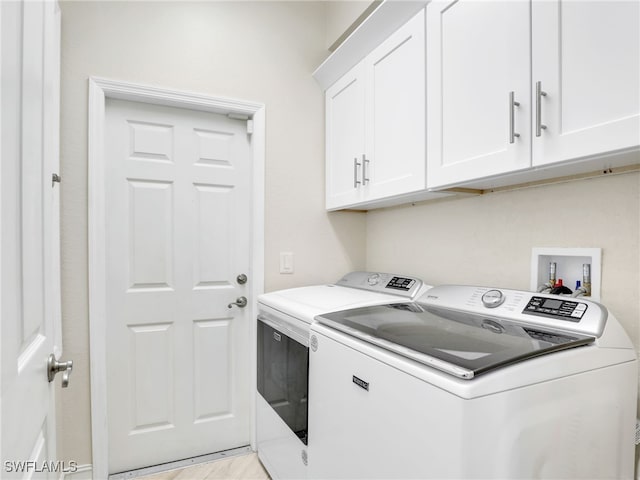 laundry room with cabinets and washing machine and dryer