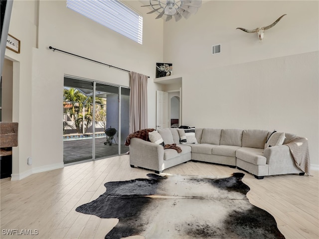 living room with ceiling fan and light wood-type flooring