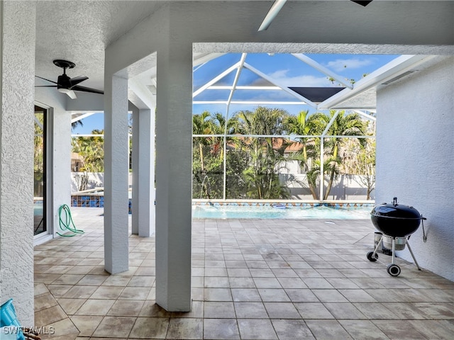 view of patio / terrace featuring area for grilling, a lanai, and ceiling fan