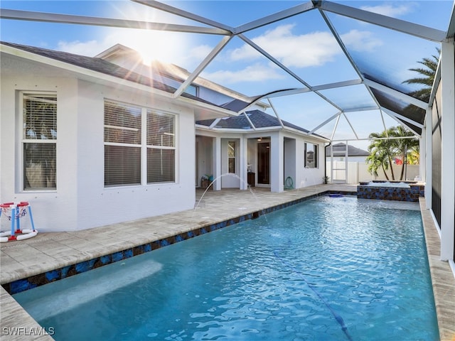 view of pool with an in ground hot tub, a lanai, and a patio area