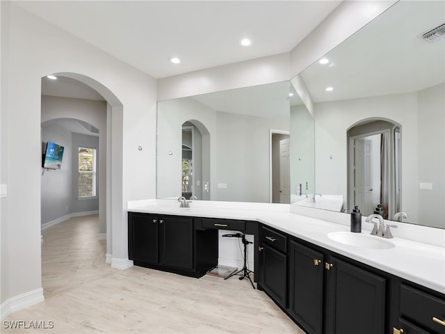 bathroom with vanity and wood-type flooring