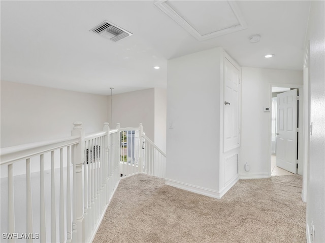 corridor with light colored carpet