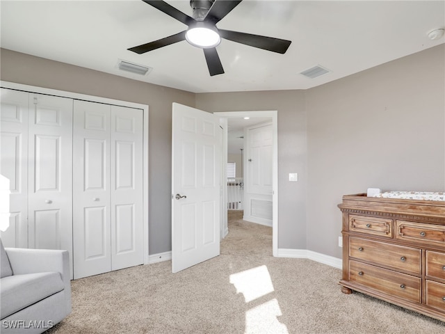 bedroom with ceiling fan, a closet, and light carpet