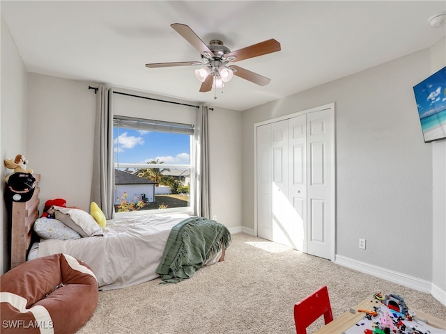 carpeted bedroom featuring a closet and ceiling fan