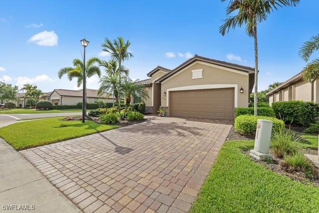 view of front facade with a garage and a front lawn