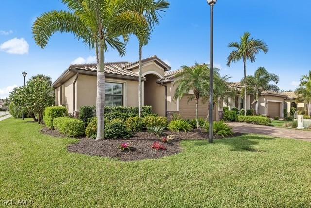 view of front of property with a garage and a front yard