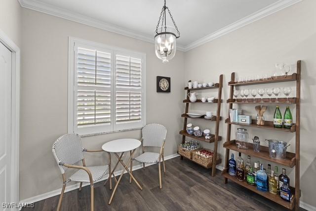 dining space featuring ornamental molding, dark hardwood / wood-style flooring, and a notable chandelier