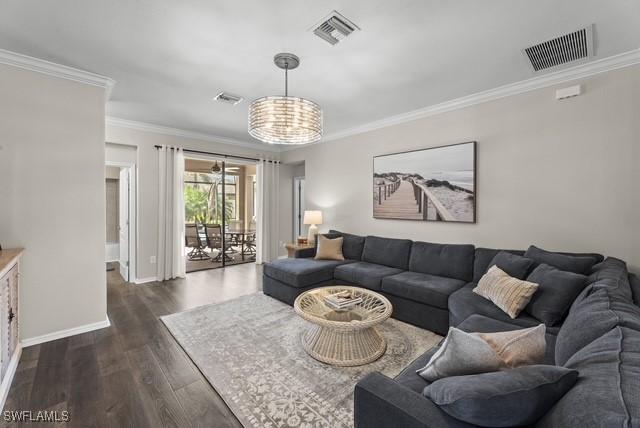 living room featuring dark hardwood / wood-style flooring and crown molding