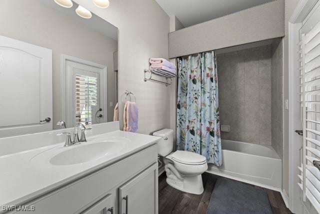 full bathroom featuring hardwood / wood-style flooring, vanity, toilet, and shower / bath combination with curtain